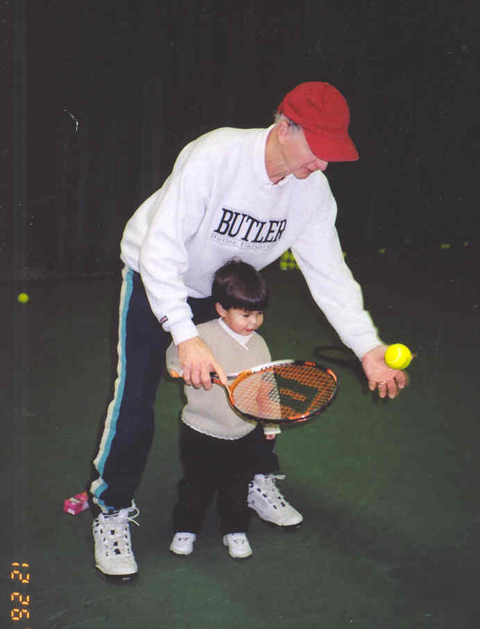 Ed Brune teaching a young tennis player